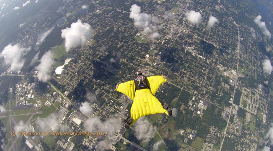 bill vance borrows scotty's wingsuit on one of his training jumps at skydive university